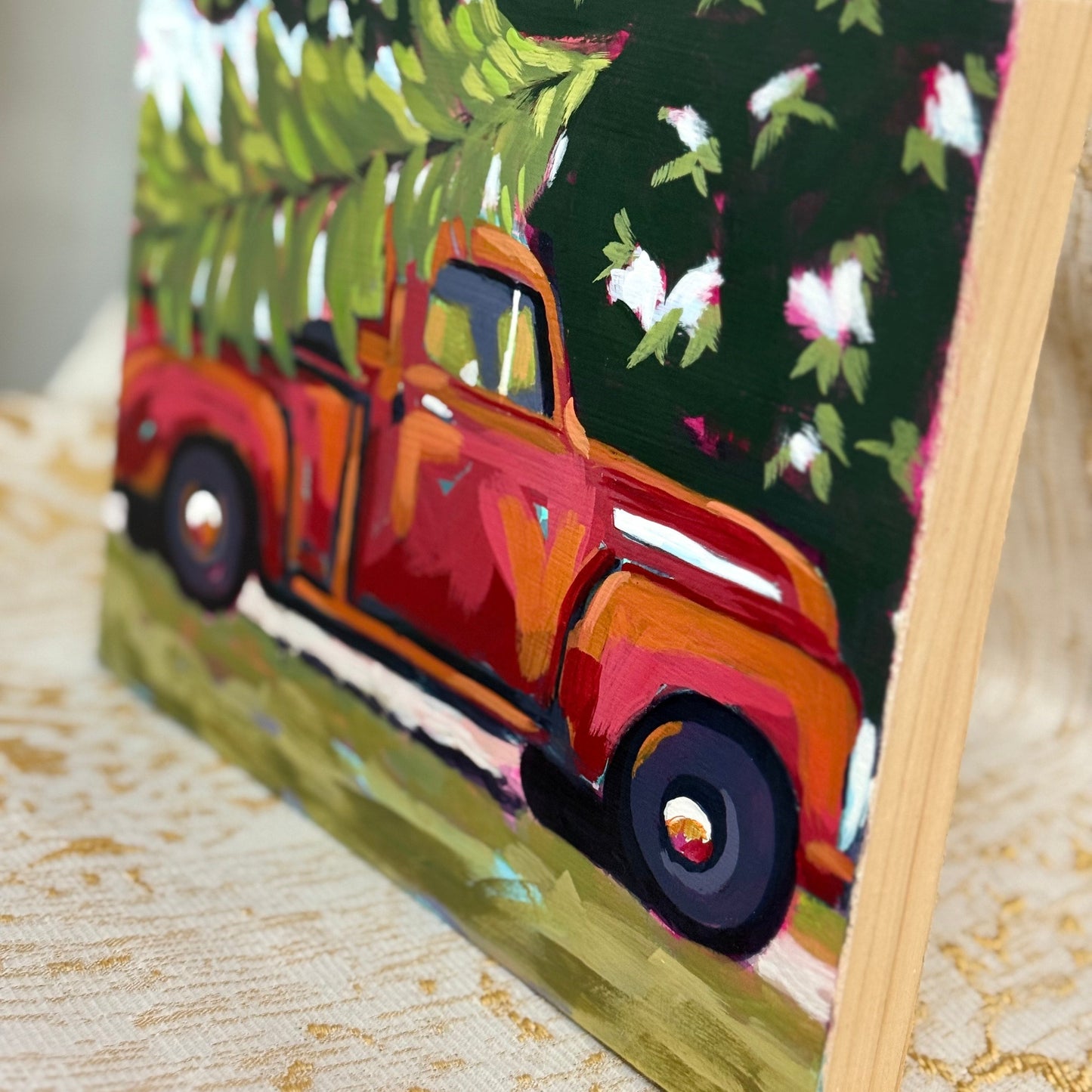 Painting of a vintage truck with a Christmas tree on a stand