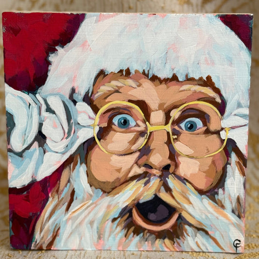Cradle board painting of a stylized portrait of Santa with a white beard and glasses on a textured surface. 